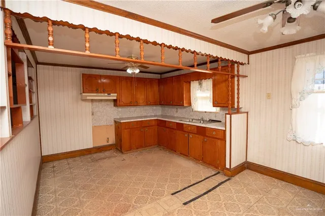 a kitchen with a sink and a refrigerator