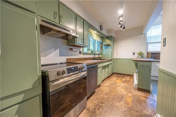a kitchen with a sink stove and cabinets
