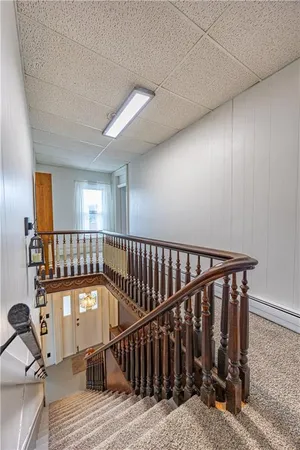 a view of a hallway with wooden floor and stairs