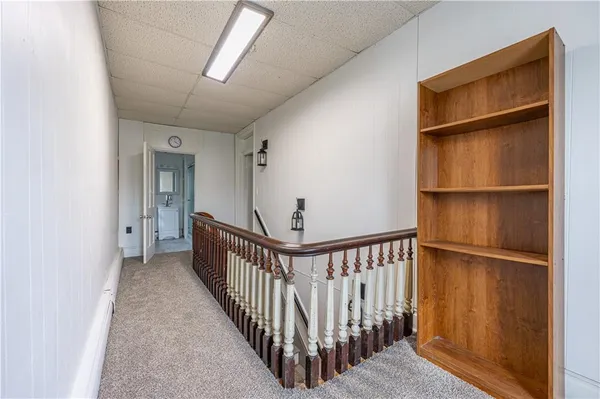 a view of a hallway with wooden floor and entryway