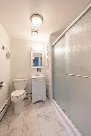 a bathroom with a sink toilet and shower