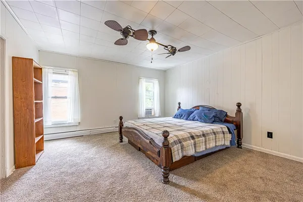 a spacious bedroom with a bed and a window