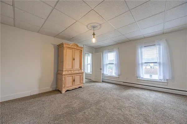 a view of empty room with window and ceiling fan