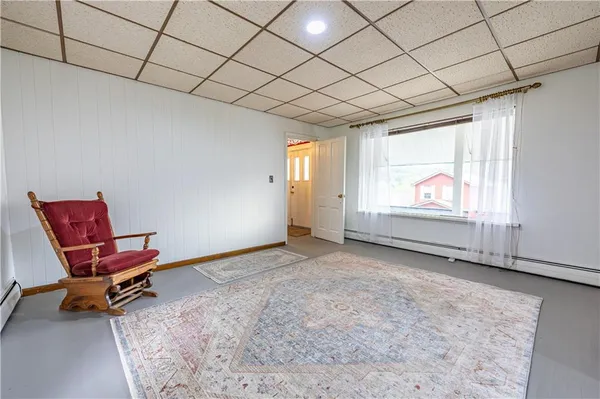 a view of a room with gym equipment and wooden floor
