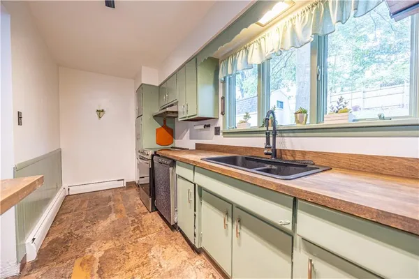 a kitchen with stainless steel appliances granite countertop a sink and a stove