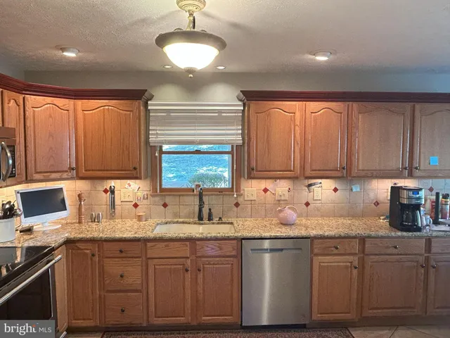 a living room with furniture rug and a window