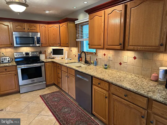 a living room with furniture a dining table and kitchen view