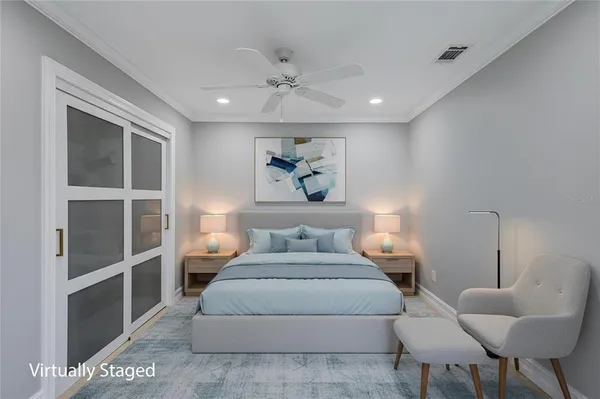 a bedroom with a large bed and a chandelier