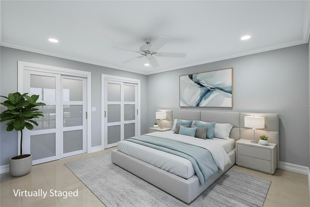 4403 7th Street East, Unit 4 Ellenton, FL 34222 - Photo 14 of 25 a bedroom with a large bed and a potted plant