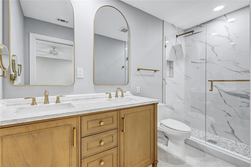 4403 7th Street East, Unit 4 Ellenton, FL 34222 - Photo 15 of 25 a bathroom with a granite countertop sink toilet and shower