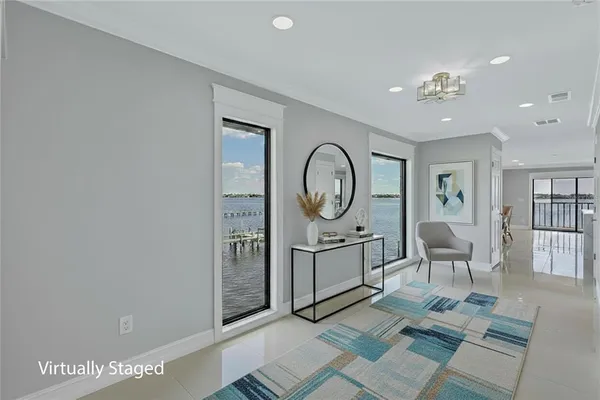 a living room with furniture a window and a clock