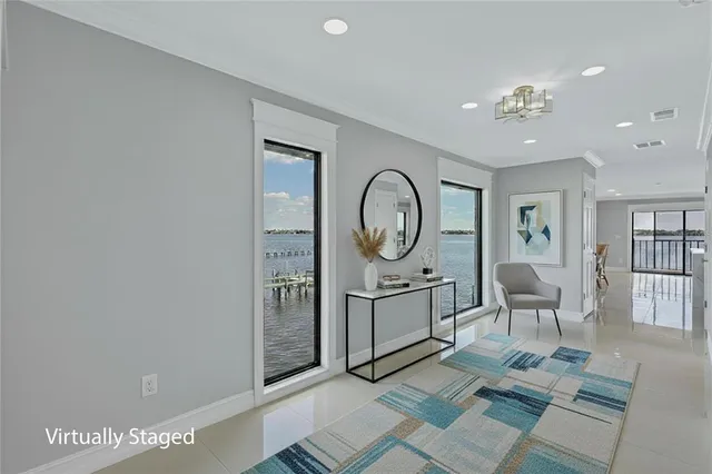 a living room with furniture a window and a clock