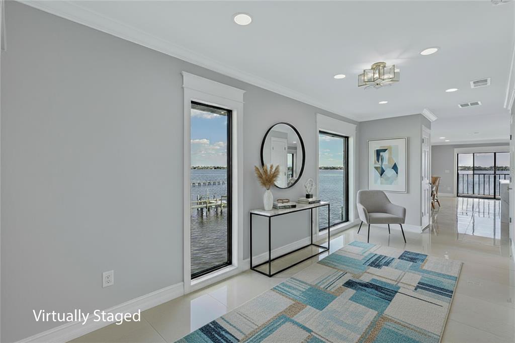 4403 7th Street East, Unit 4 Ellenton, FL 34222 - Photo 2 of 19 a living room with furniture a window and a clock