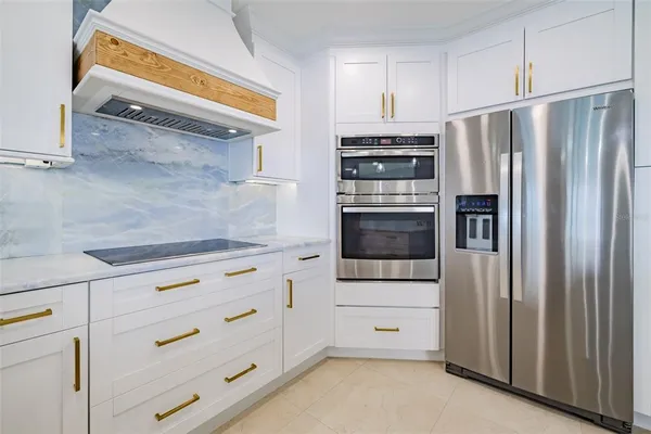 a kitchen with stainless steel appliances a refrigerator and cabinets