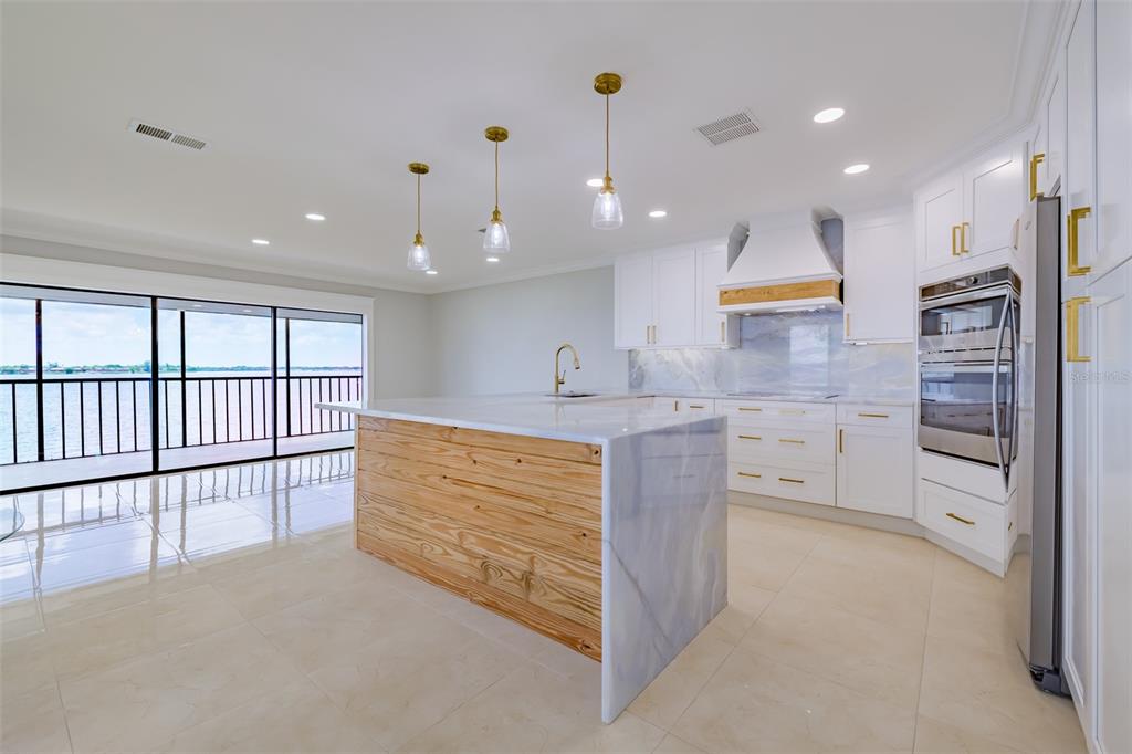 4403 7th Street East, Unit 4 Ellenton, FL 34222 - Photo 8 of 25 a large kitchen with stainless steel appliances kitchen island large windows and a chandelier