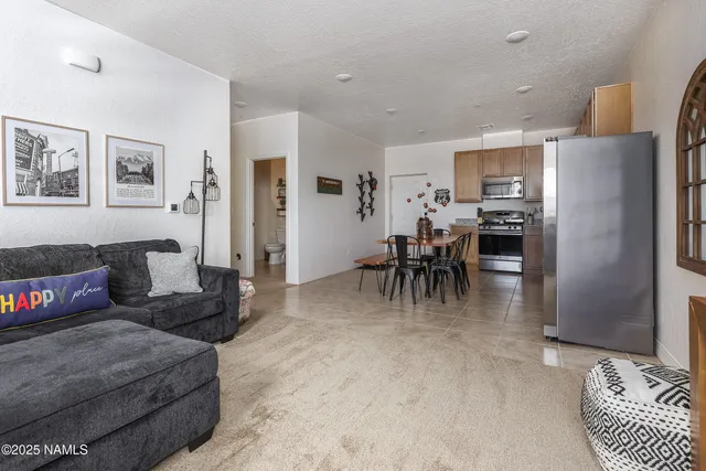 a dining room with furniture and a kitchen view