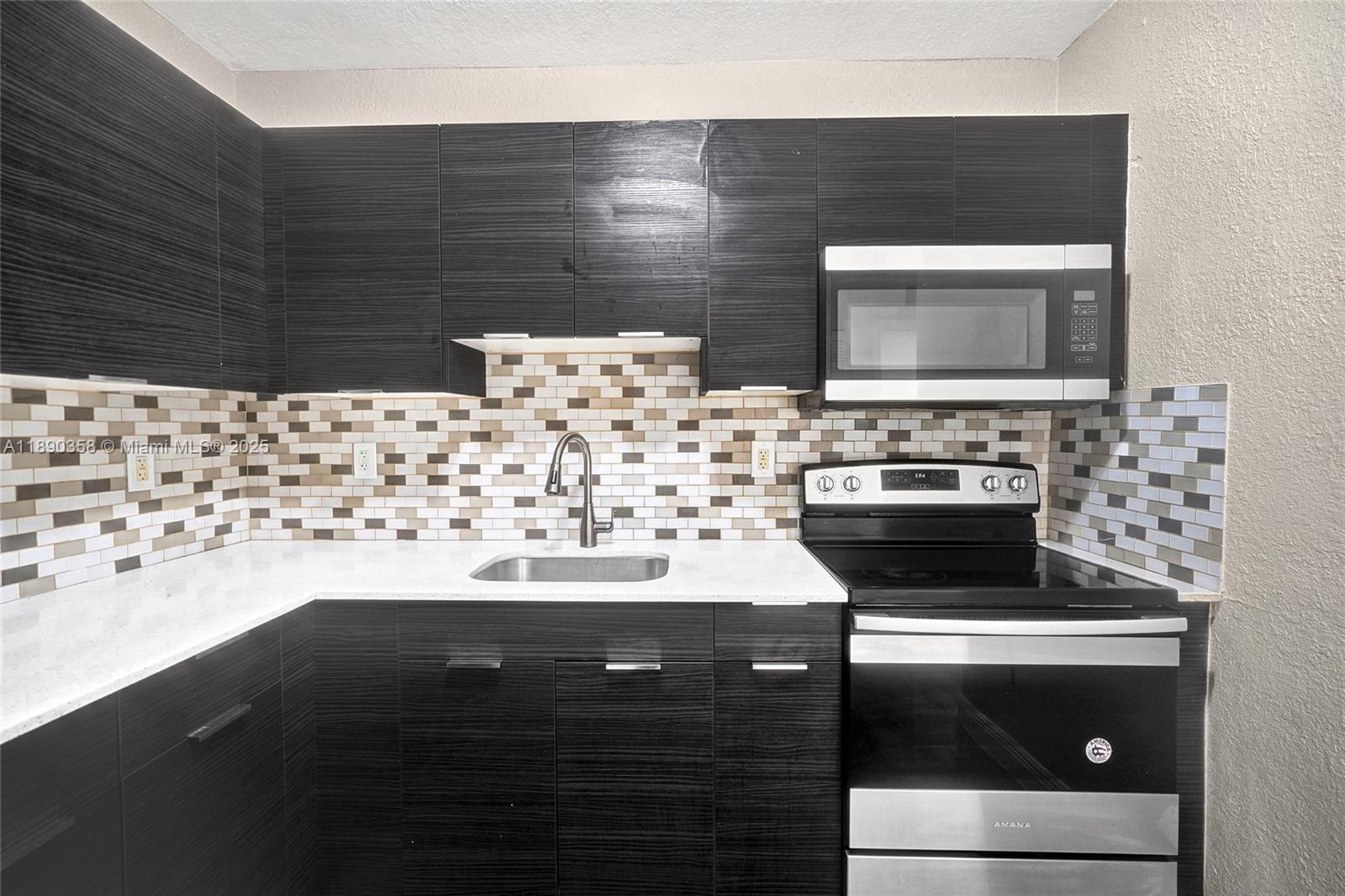 2731 Northwest 1st Street, Unit 3 Pompano Beach, FL 33069 - Photo 12 of 20 a bathroom with a sink and a stove