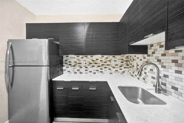 a kitchen with a sink and a refrigerator