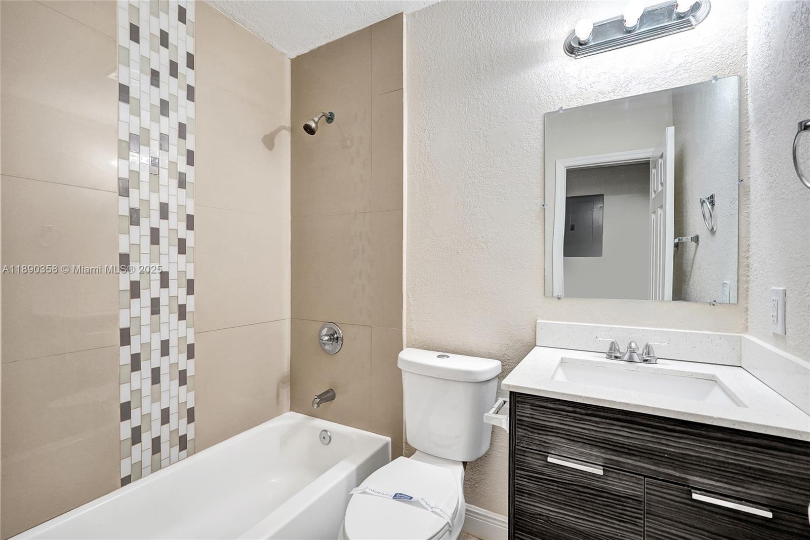 2731 Northwest 1st Street, Unit 3 Pompano Beach, FL 33069 - Photo 14 of 20 a bathroom with a sink toilet and shower