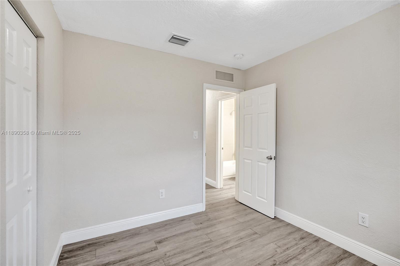 2731 Northwest 1st Street, Unit 3 Pompano Beach, FL 33069 - Photo 17 of 20 a view of an empty room and wooden floor