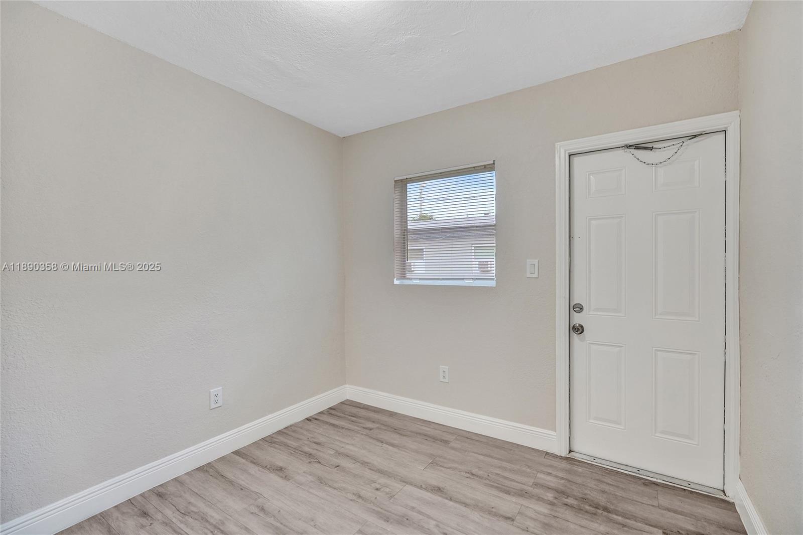 2731 Northwest 1st Street, Unit 3 Pompano Beach, FL 33069 - Photo 19 of 20 an empty room with wooden floor and closet