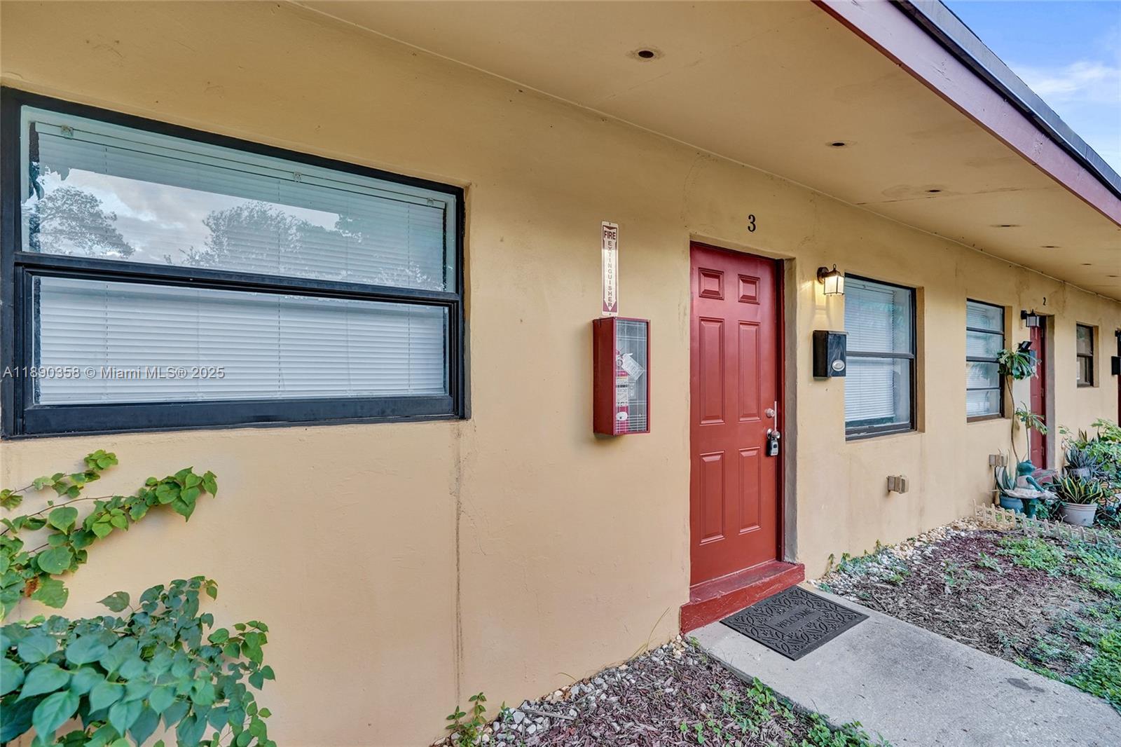 2731 Northwest 1st Street, Unit 3 Pompano Beach, FL 33069 - Photo 20 of 20 a front view of a house with plants