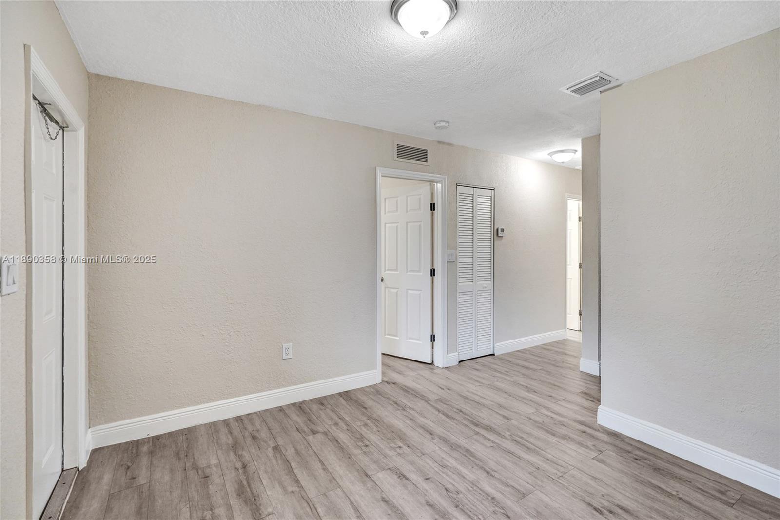 2731 Northwest 1st Street, Unit 3 Pompano Beach, FL 33069 - Photo 7 of 20 a view of an empty room and wooden floor