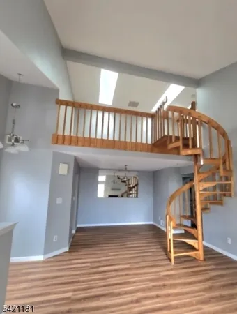 a view of an entryway with wooden floor