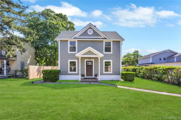 a front view of a house with a yard and pathway