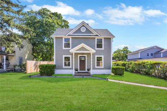 a front view of a house with a yard and pathway