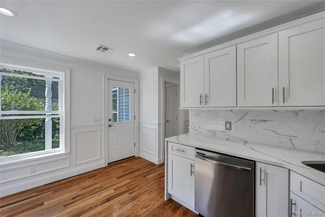 a kitchen with a sink cabinets and wooden floor