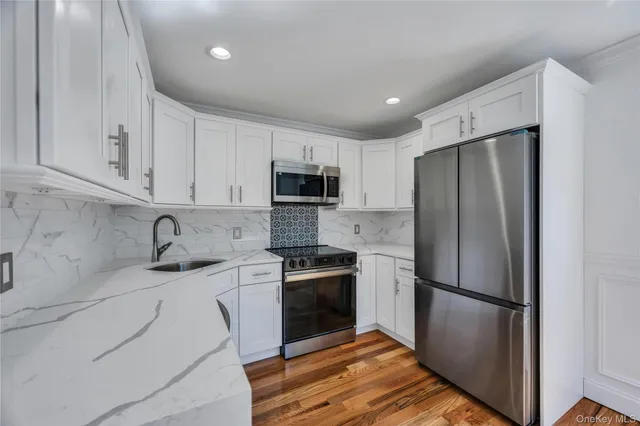 a kitchen with a refrigerator sink and microwave