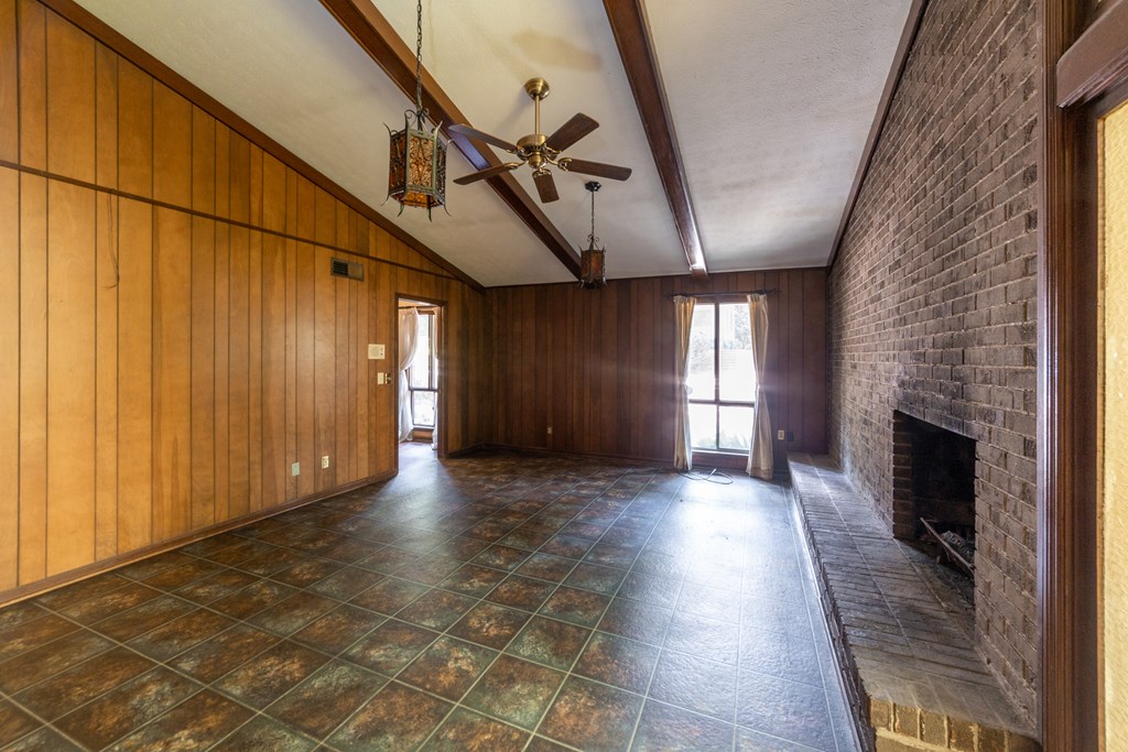 2724 Edgewood Road Columbus, GA 31906 - Photo 8 of 22 a view of empty room with wooden floor and fireplace