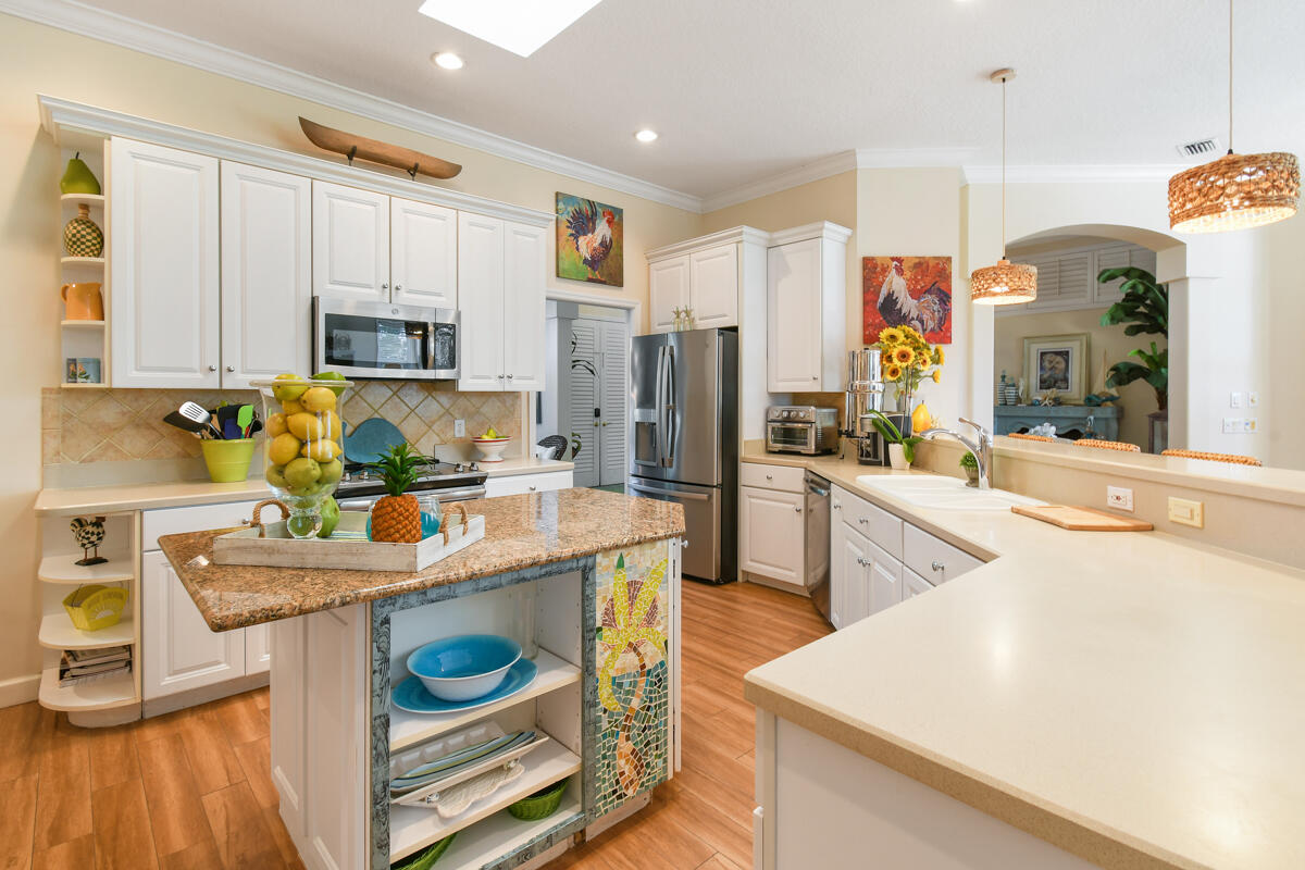 7831 Southeast Windjammer Way Hobe Sound, FL 33455 - Photo 16 of 80 a kitchen with stainless steel appliances granite countertop a sink stove and refrigerator