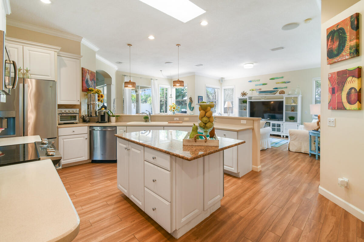 7831 Southeast Windjammer Way Hobe Sound, FL 33455 - Photo 17 of 80 a kitchen with stainless steel appliances granite countertop a sink and a refrigerator