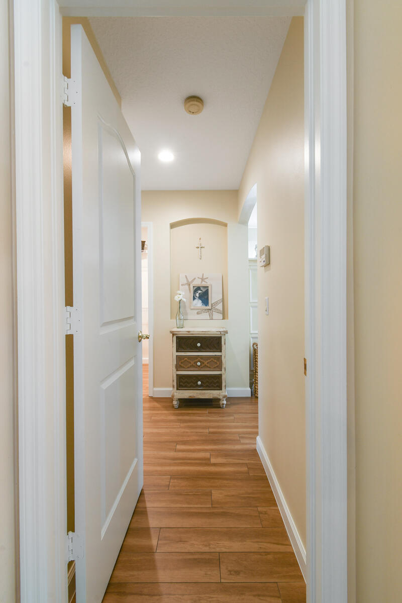 7831 Southeast Windjammer Way Hobe Sound, FL 33455 - Photo 24 of 80 a view of a hallway view with wooden floor and furniture