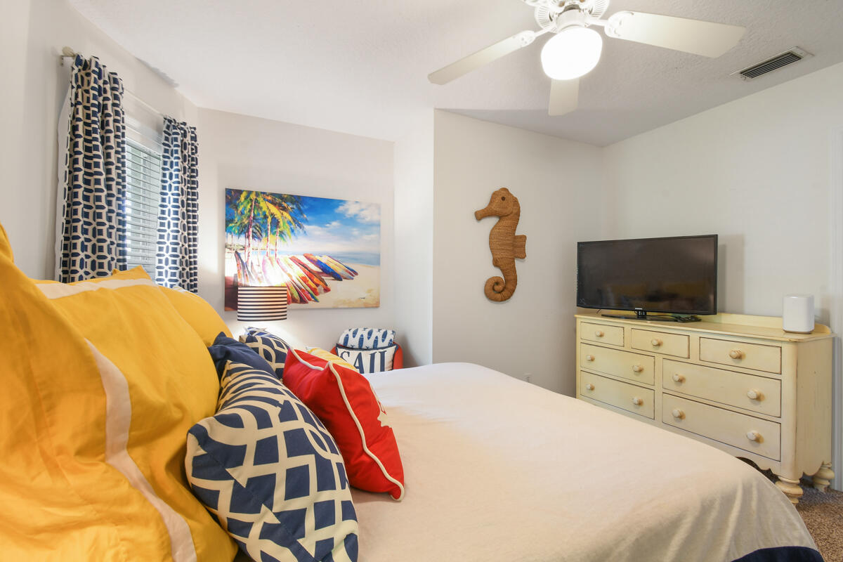 7831 Southeast Windjammer Way Hobe Sound, FL 33455 - Photo 35 of 80 a bedroom with a bed and a television