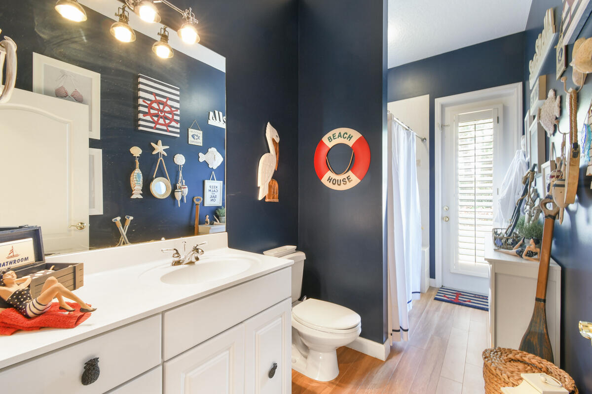 7831 Southeast Windjammer Way Hobe Sound, FL 33455 - Photo 37 of 80 a bathroom with a sink and a mirror