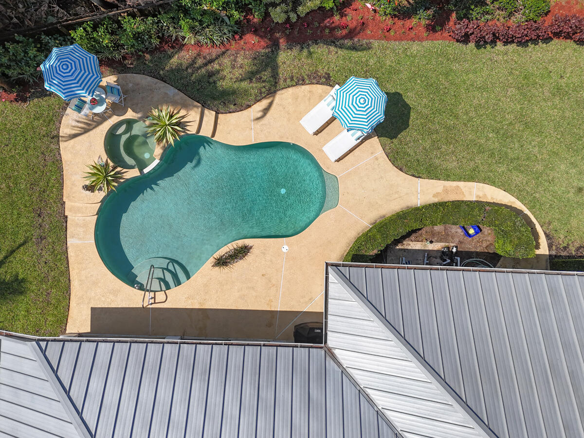 7831 Southeast Windjammer Way Hobe Sound, FL 33455 - Photo 4 of 80 a view of a wooden floor and a yard in the back