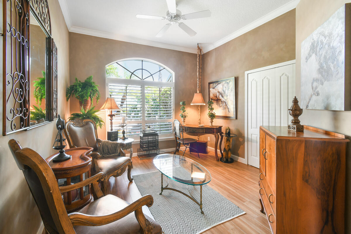 7831 Southeast Windjammer Way Hobe Sound, FL 33455 - Photo 42 of 80 a living room with furniture a wooden floor and a large window