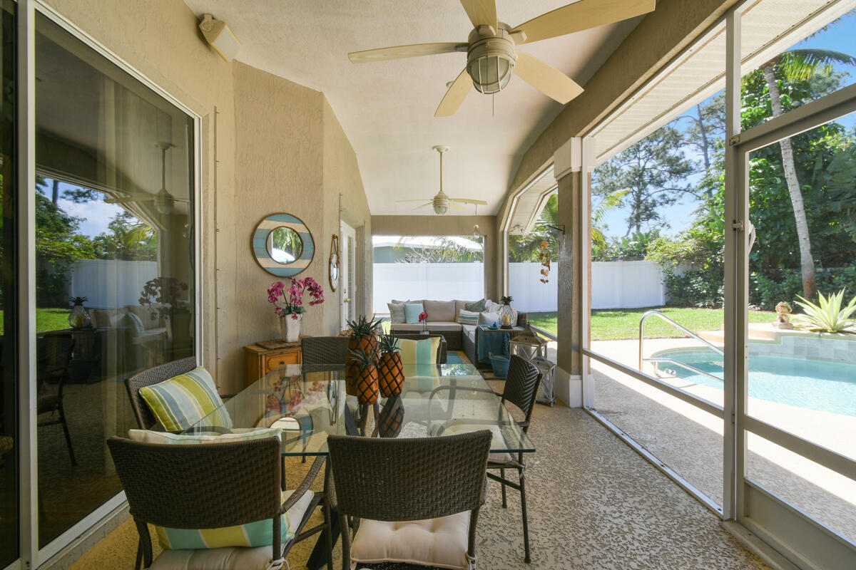 7831 Southeast Windjammer Way Hobe Sound, FL 33455 - Photo 46 of 80 a dining room with furniture a large window and outside view