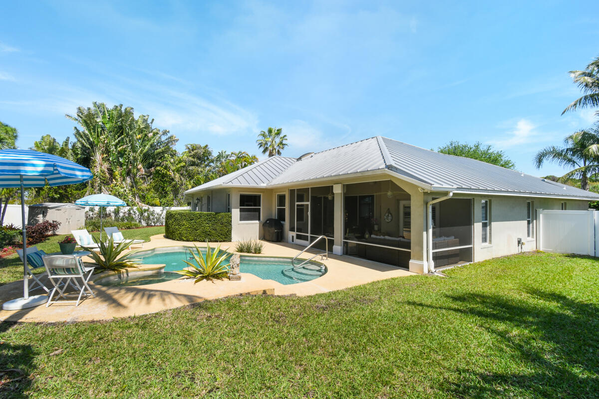 7831 Southeast Windjammer Way Hobe Sound, FL 33455 - Photo 50 of 80 a view of a house with backyard porch and sitting area