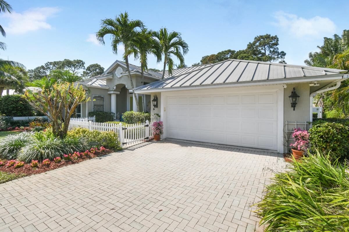 7831 Southeast Windjammer Way Hobe Sound, FL 33455 - Photo 54 of 80 a front view of a house with a garden