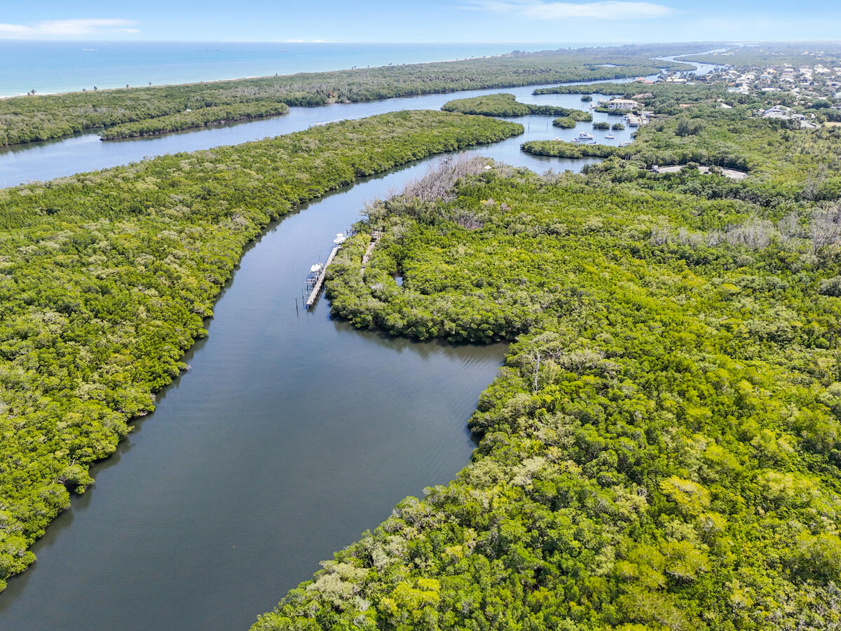 7831 Southeast Windjammer Way Hobe Sound, FL 33455 - Photo 61 of 80 a view of a lake with a mountain in the background