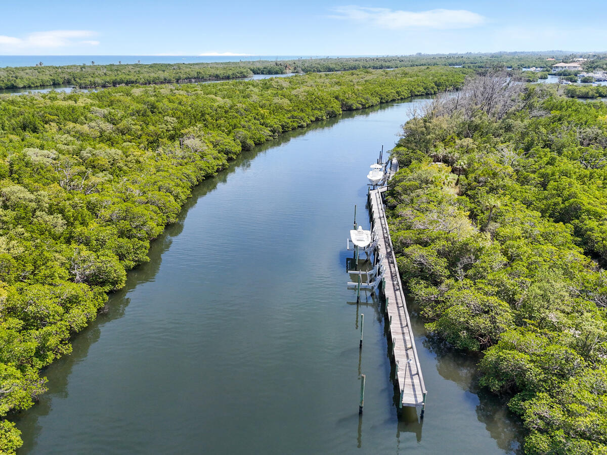 7831 Southeast Windjammer Way Hobe Sound, FL 33455 - Photo 63 of 80 a view of a lake with a outdoor space