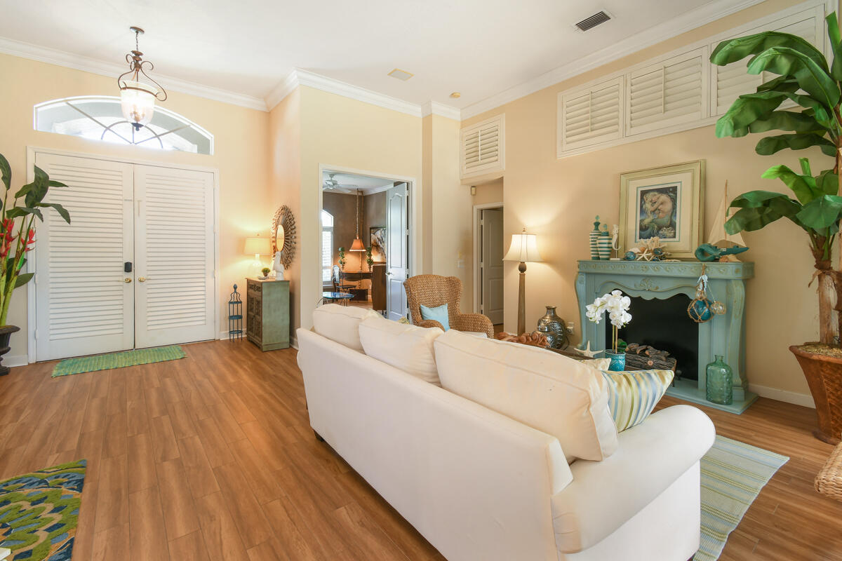 7831 Southeast Windjammer Way Hobe Sound, FL 33455 - Photo 7 of 80 a living room with furniture and a chandelier