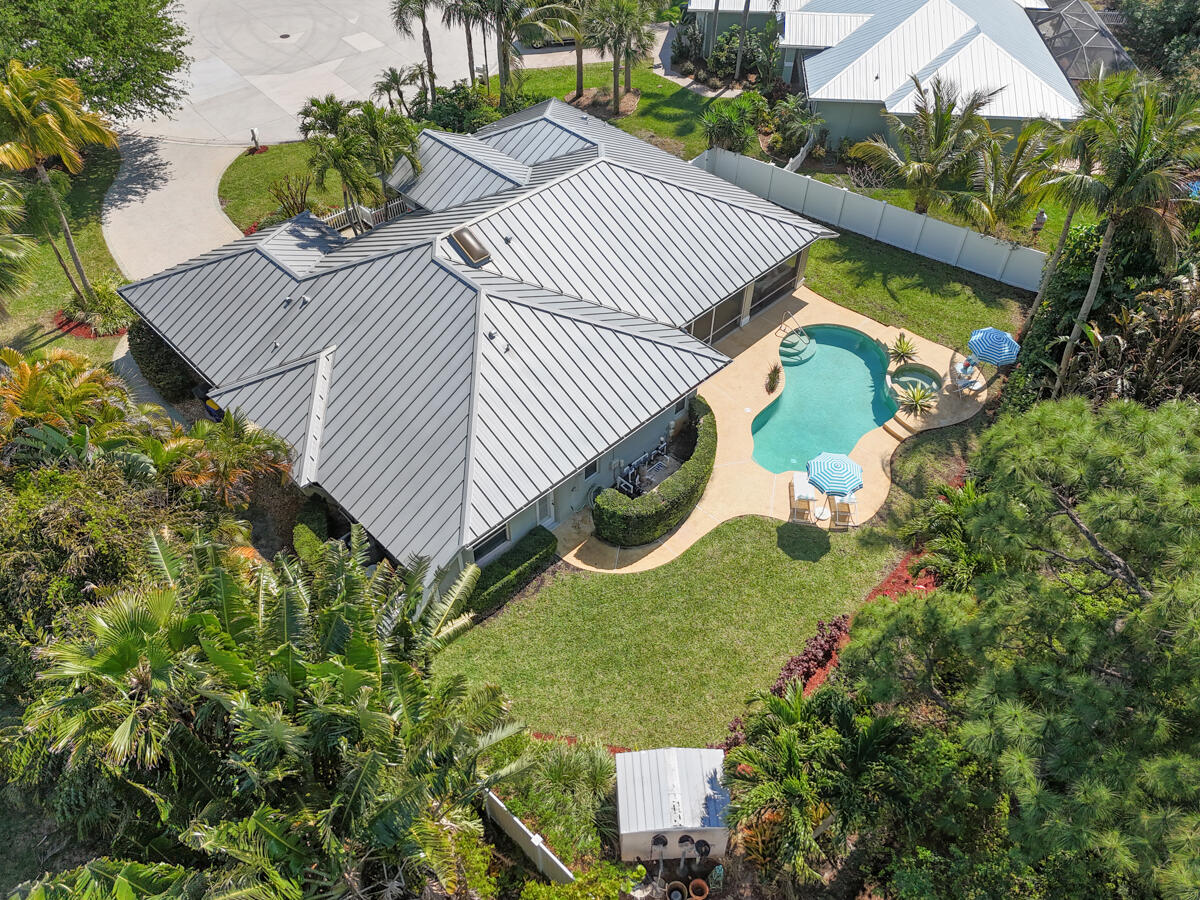 7831 Southeast Windjammer Way Hobe Sound, FL 33455 - Photo 74 of 80 an aerial view of a house with swimming pool a patio and yard
