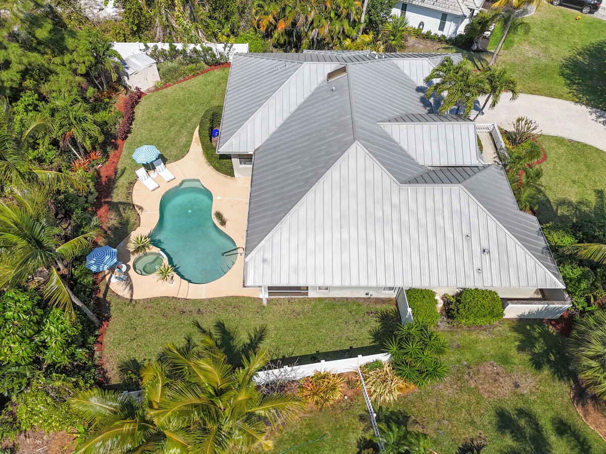 7831 Southeast Windjammer Way Hobe Sound, FL 33455 - Photo 77 of 80 a view of a house with a yard and sitting area