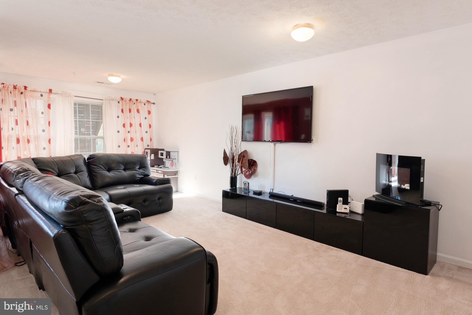 802 Tipton Road Middle River, MD 21220 - Photo 21 of 30 a living room with furniture and a flat screen tv