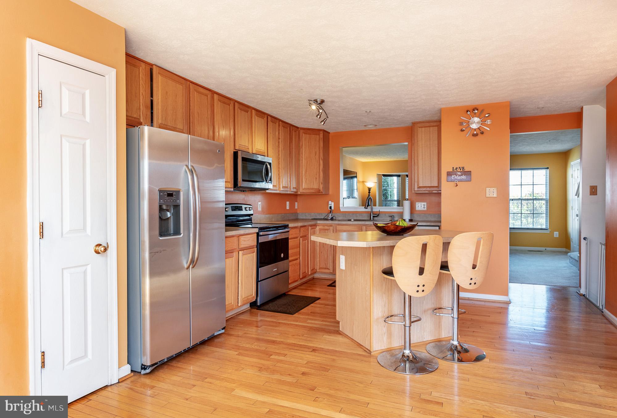 802 Tipton Road Middle River, MD 21220 - Photo 7 of 30 a kitchen with stainless steel appliances granite countertop a refrigerator a stove top oven and a sink